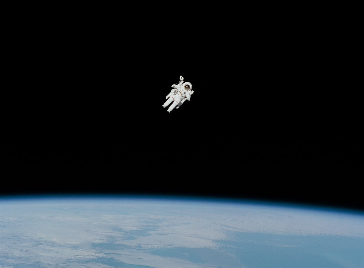 NASA astronaut Bruce McCandless on an untethered spacewalk above Earth